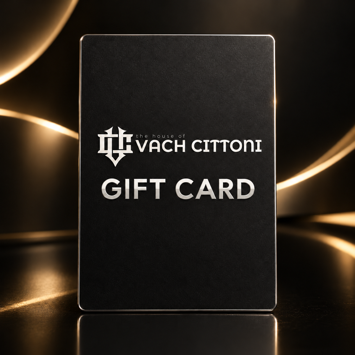 Carte-cadeau Vach Cittoni avec nœud argenté et logo officiel de la Maison sur fond noir et or